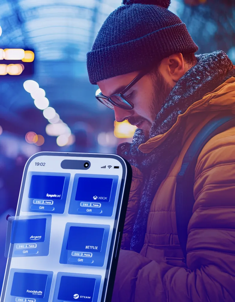 Website image style: a man in a winter jacket with a phone full of gift cards