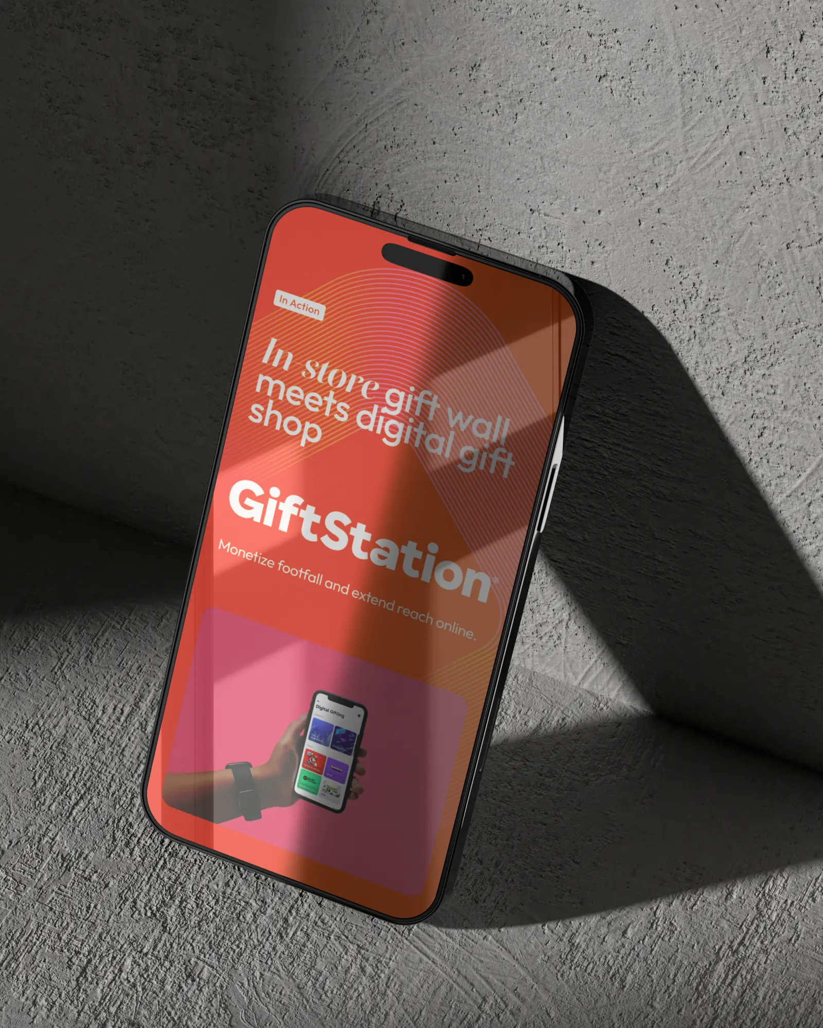 Phone leaning on a wall showing the GiftStation page