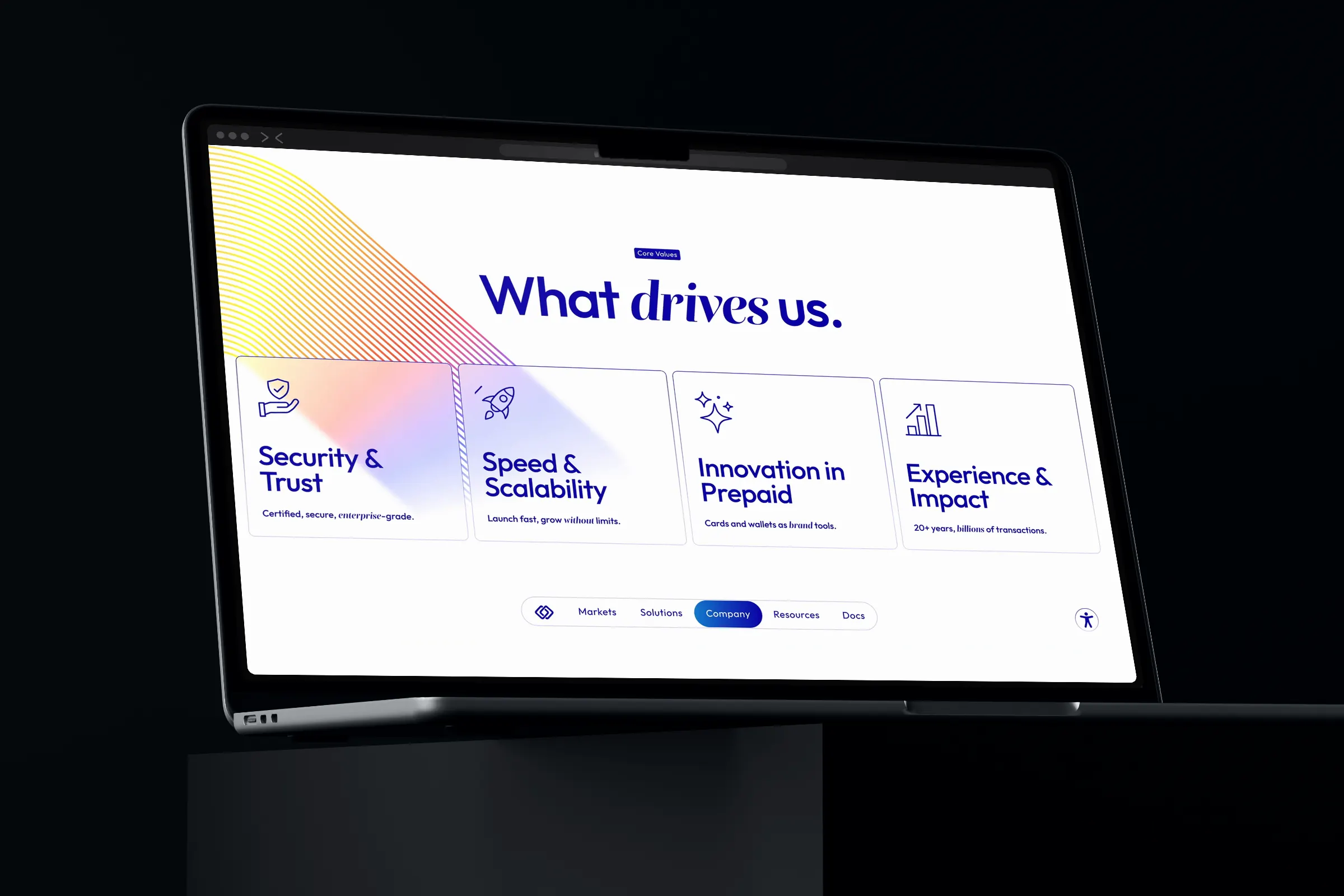 Laptop in a dark room showing “What drives us.” with four value cards