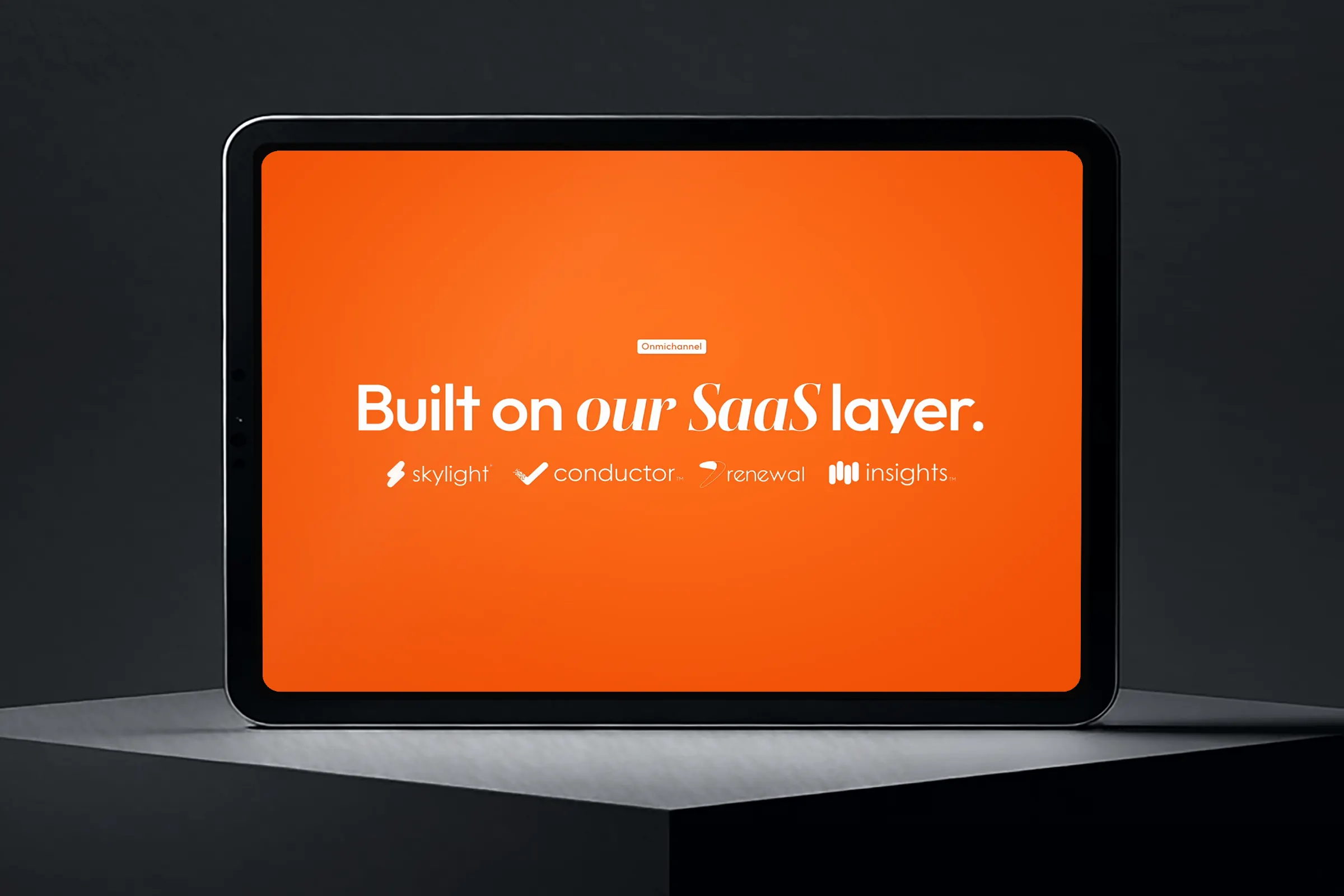 Tablet on a plinth showing “Built on our SaaS layer.” in epay orange