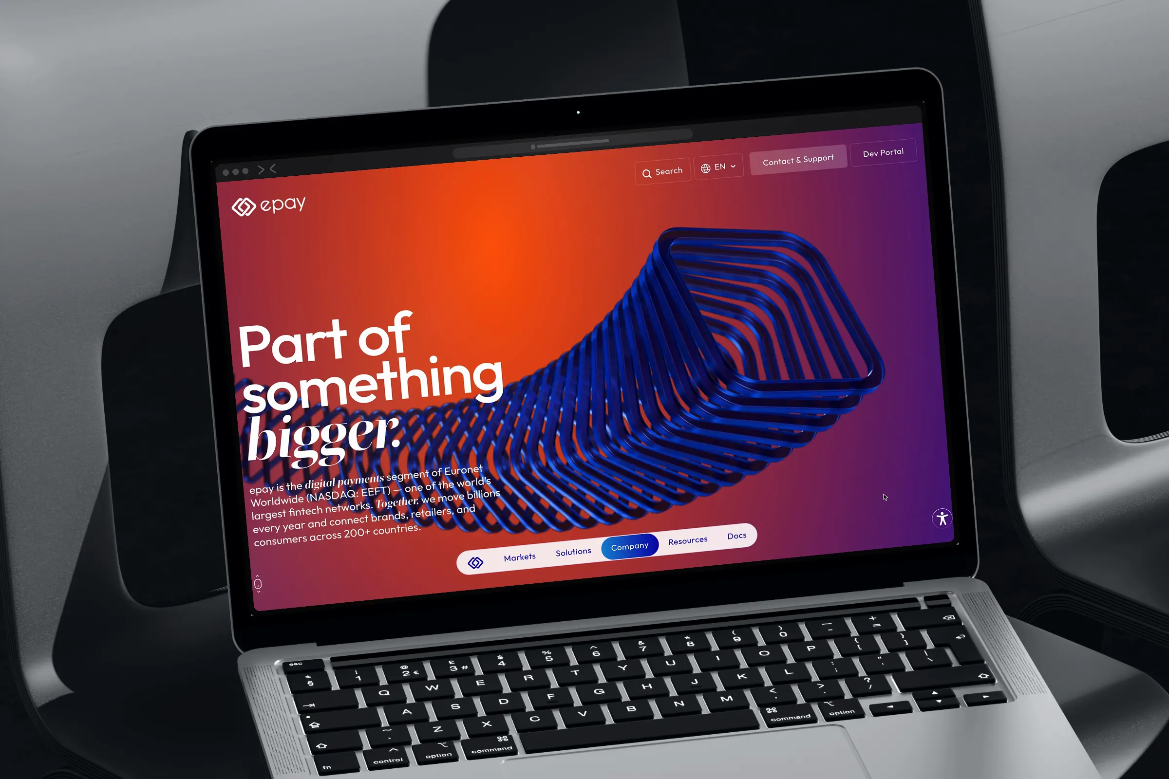 Laptop on a chair showing “Part of something bigger.”