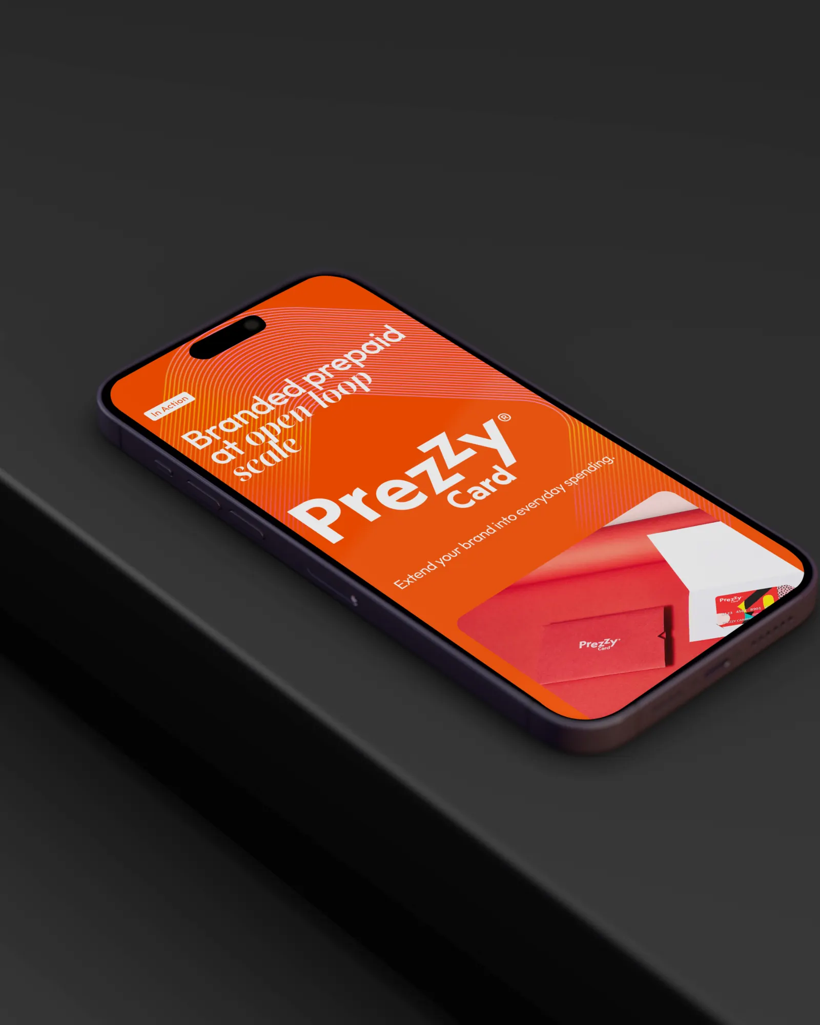 Phone lying on a dark ledge showing the Prezzy Card page