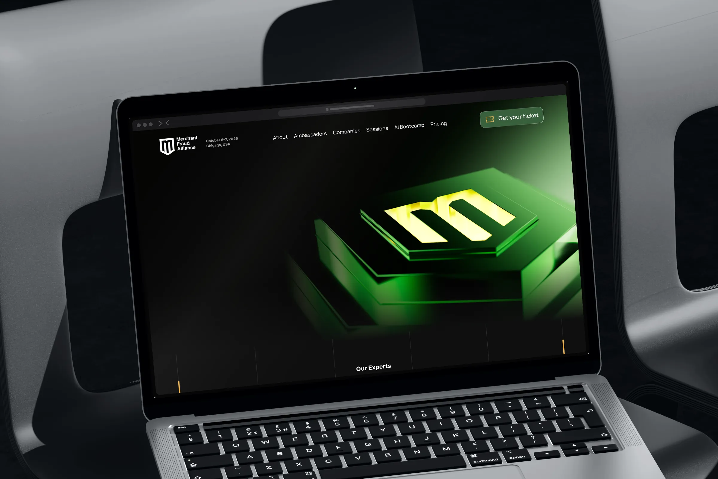 Laptop on a black chair showing the AI Bootcamp page with the green 3D shield