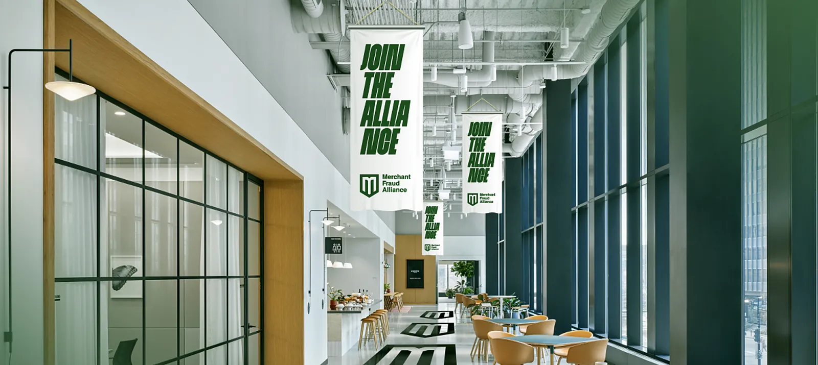 The venue hall with hanging Join the Alliance banners and the M on the floor