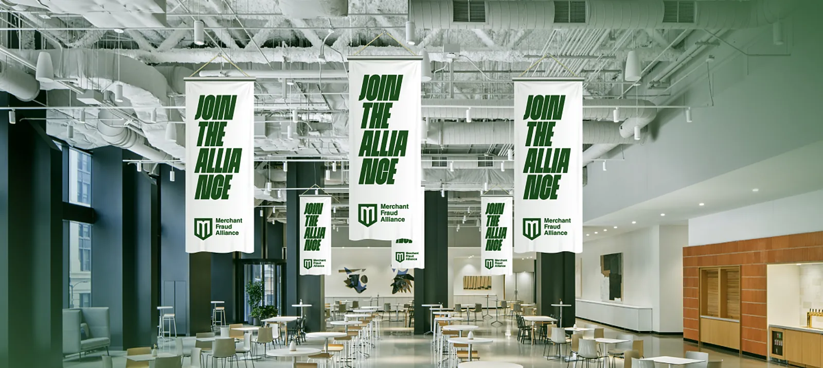 A bright hall with long white Join the Alliance banners hanging from the ceiling over the tables