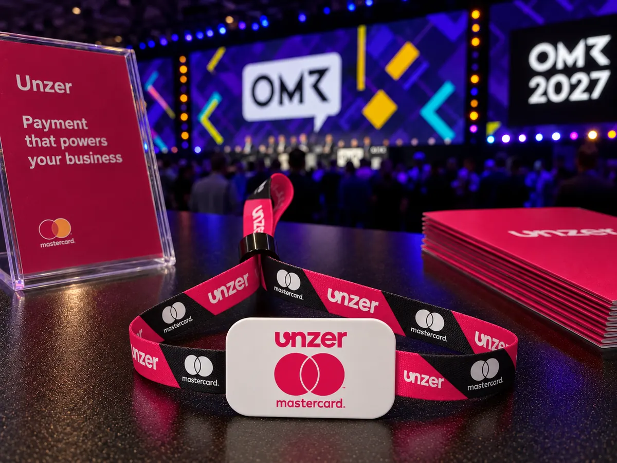 Concept: an Unzer and Mastercard payment wristband in front of the OMR 2027 stage