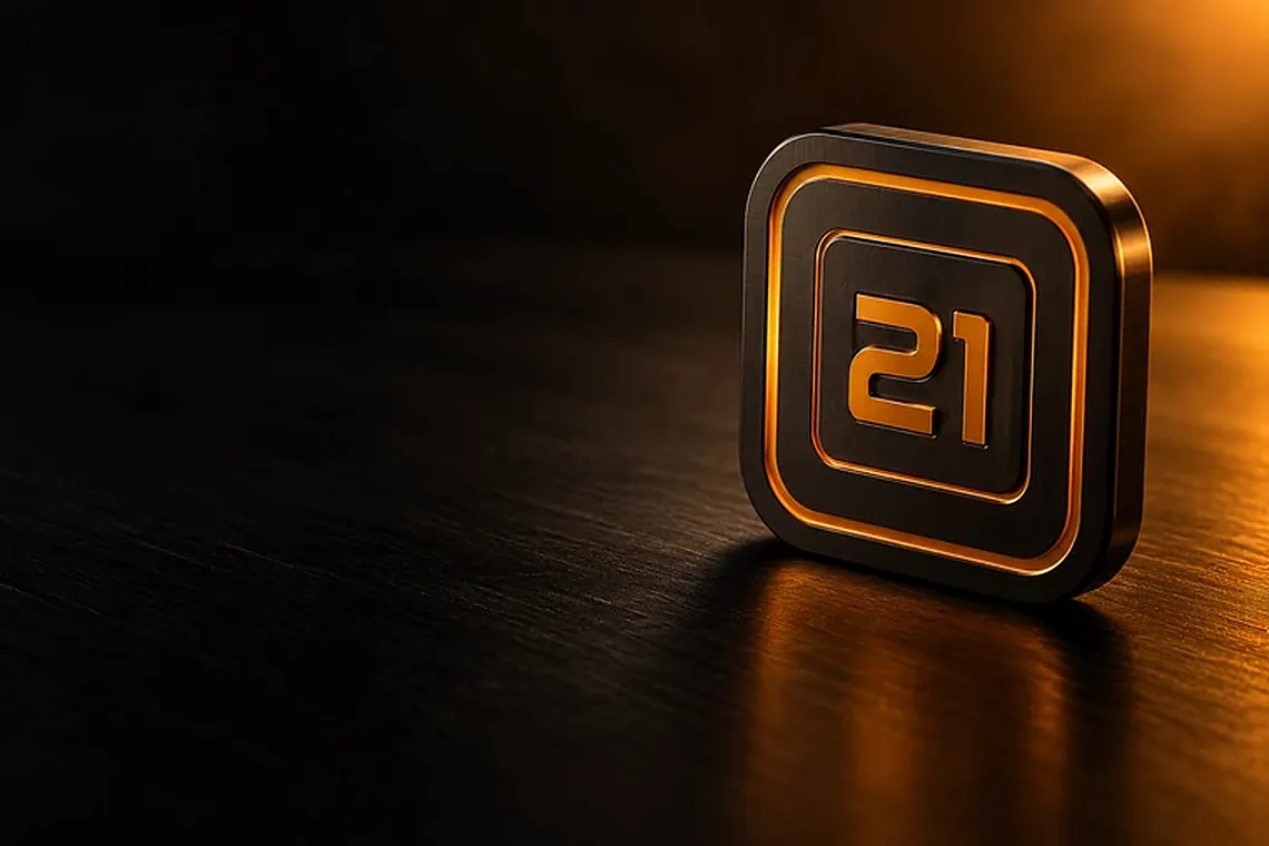A single Value Block, black with an orange 21 in relief, standing on a dark desk